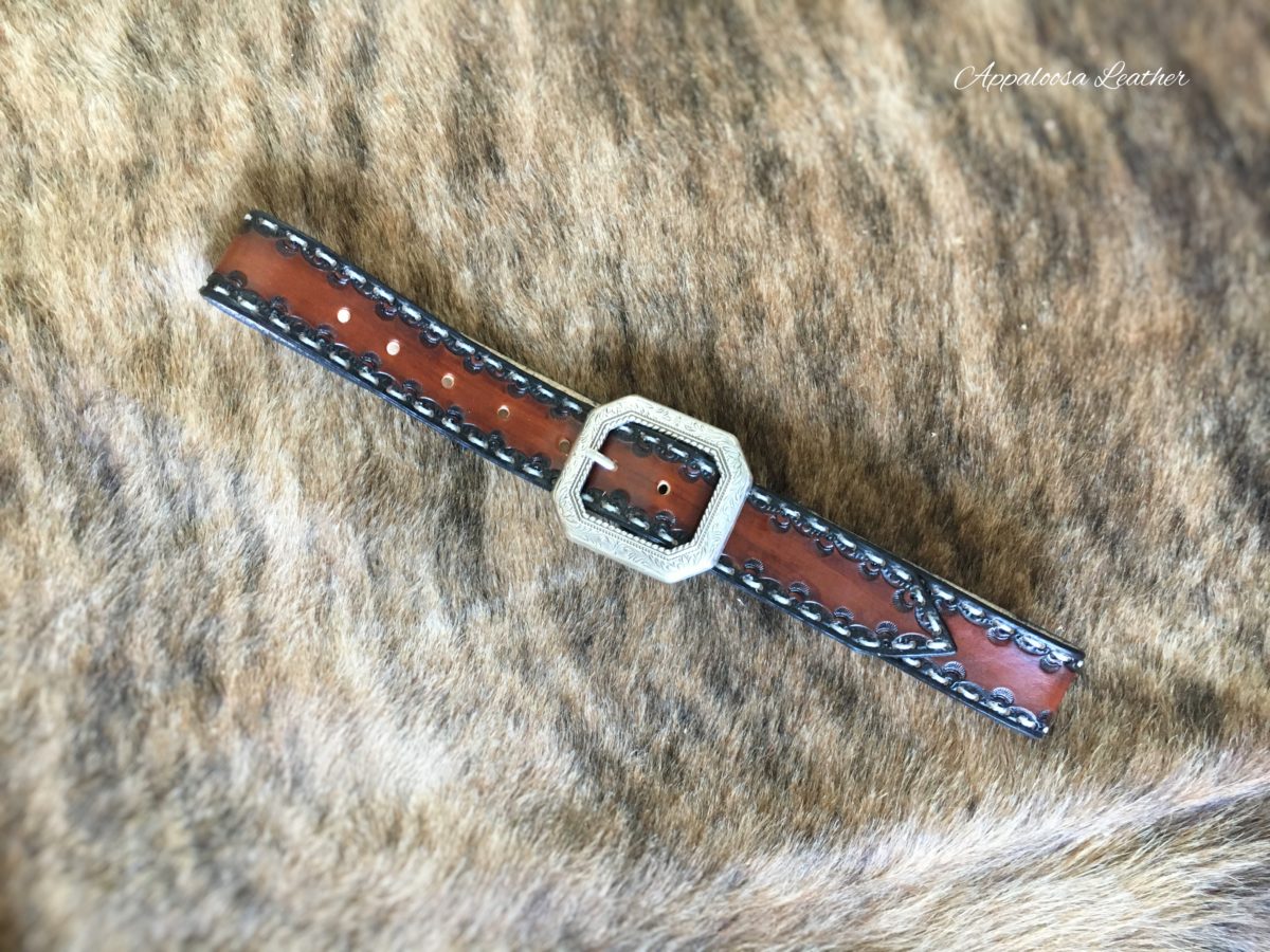 Tooled leather belt with white stitching