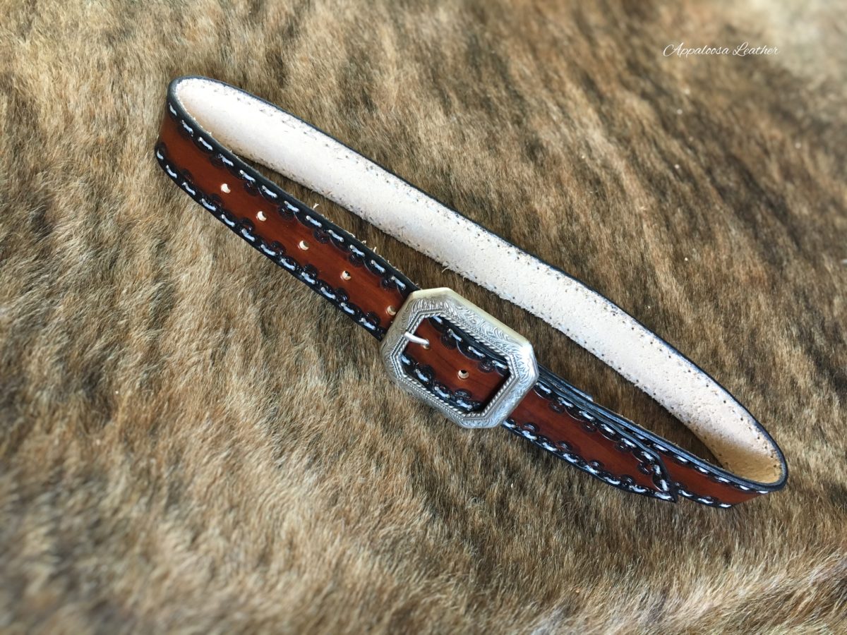 Tooled leather belt with white stitching