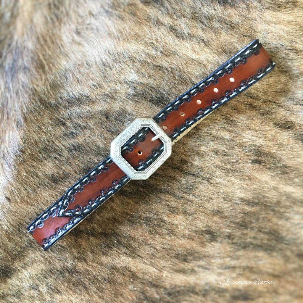 Tooled leather belt with white stitching