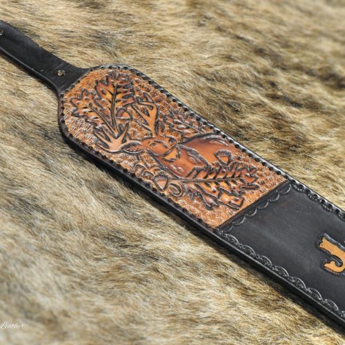 custom leather rifle sling with a whitetail deer, oak leaves and acorn with custom lettering on a dark background