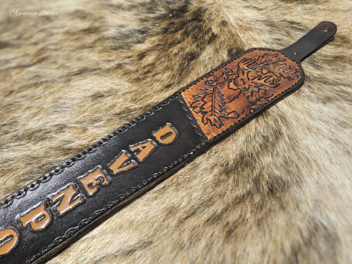 custom leather rifle sling with a whitetail deer, oak leaves and acorn with custom lettering on a dark background
